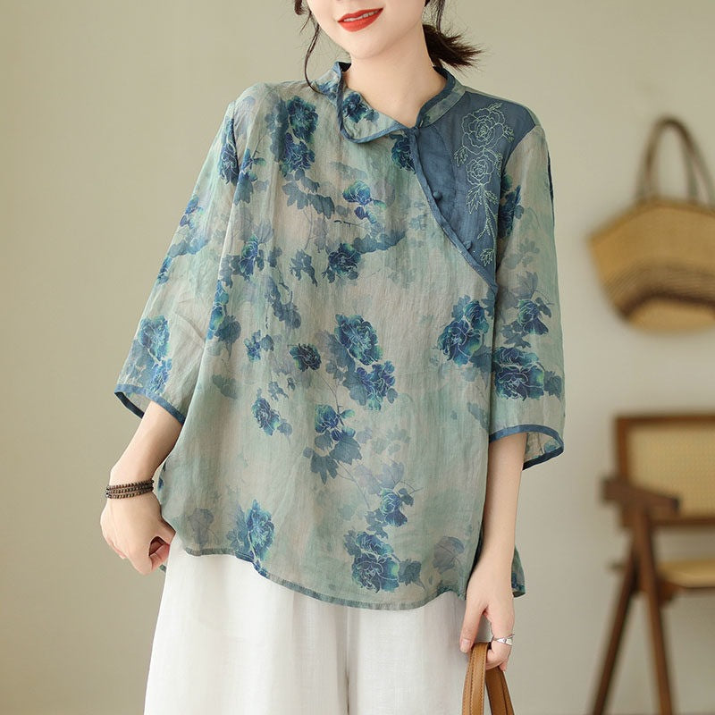 Woman wearing a loose blue floral cotton linen top with three quarter sleeves