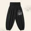 Black harem pants with white lotus and Om symbol print on the leg