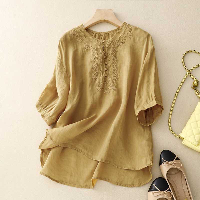 Yellow cotton linen shirt with embroidery on a hanger