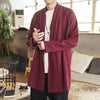 Man wearing a burgundy mid-length coat with a stand collar