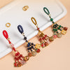 Four colorful keychains with red, blue, yellow, and green cords and enamel charms