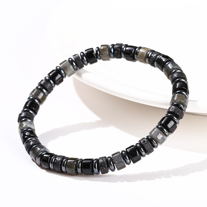 Close up of a black geometric hematite beaded bracelet on a white surface