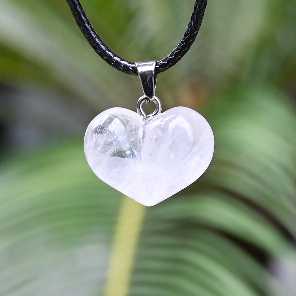 White clear quartz heart pendant on a black cord
