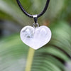 White clear quartz heart pendant on a black cord