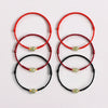 Group of six braided bracelets in red, wine red, and black with single center beads