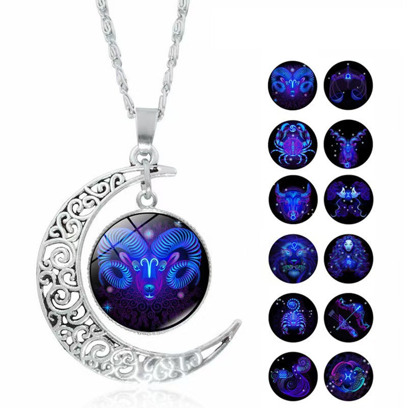 Silver tone crescent moon necklace with a rotating glass pendant showing a blue zodiac constellation.