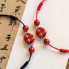 Cinnabar Flower Anklet, Red and Black Cord