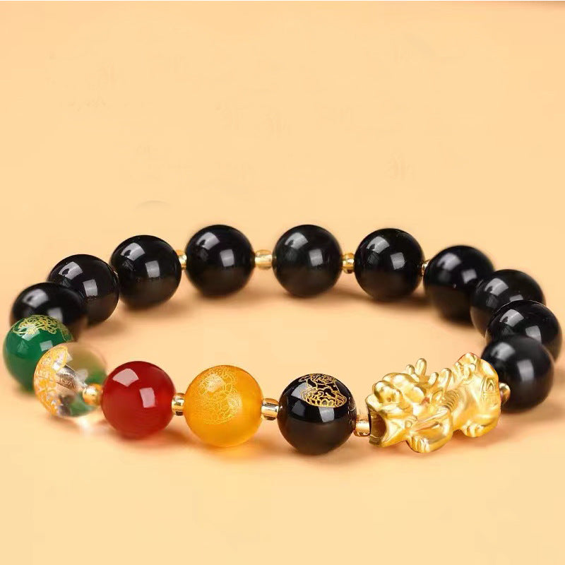 Gold-tone Pixiu charm on a beaded bracelet with black obsidian and colorful accent stones