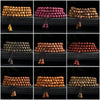 A close-up view of several wooden mala bracelets with gourd charms arranged on a dark surface.
