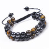 Double row beaded bracelet with brown tiger eye and black magnetite stones on a wrist