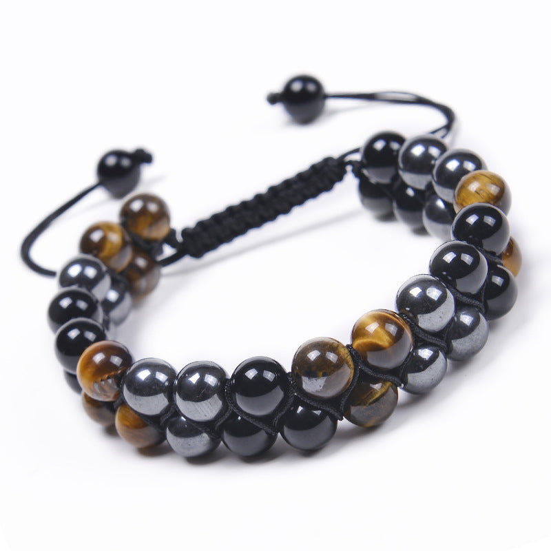 Double row beaded bracelet with brown tiger eye and black magnetite stones on a wrist