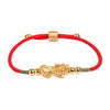Close-up of a red string bracelet with a silver Pixiu charm worn on a wrist