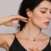 Model wearing a freshwater pearl choker necklace with a green square zircon pendant