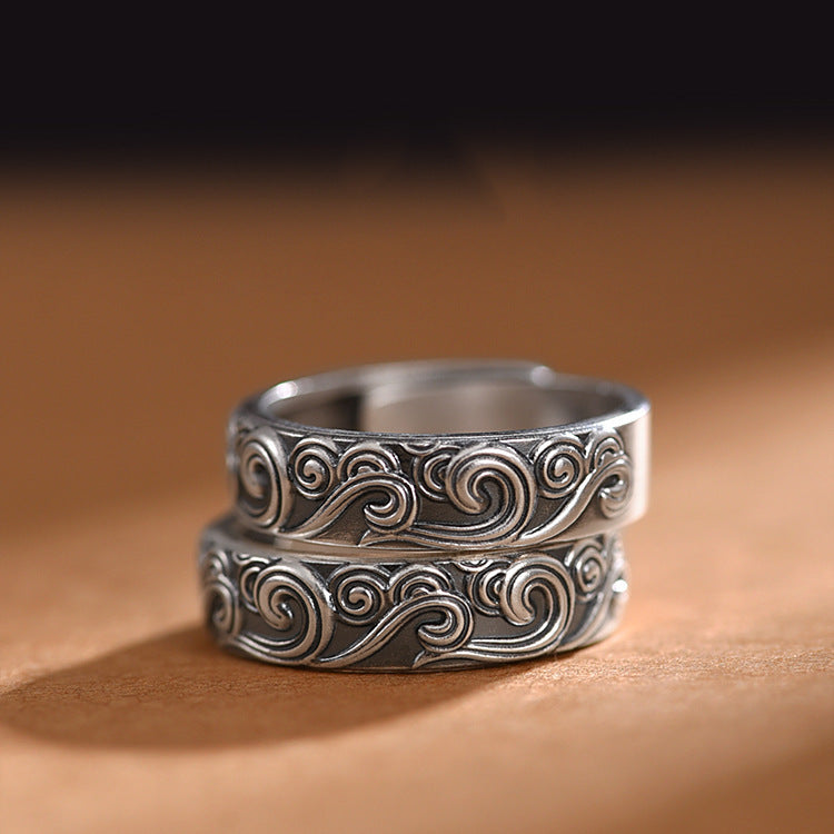 Close up of silver tone copper ring with engraved cloud swirls