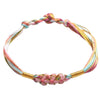 Close-up of a multicolor braided string bracelet with a pink flower knot detail