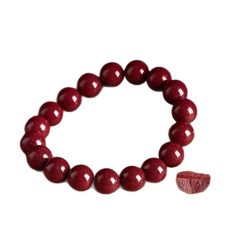 Deep red cinnabar bead bracelet on a white background