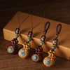 Wooden money bag keychains with rotating mantra beads in red and light wood tones