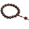 Close up of dark wood beads with gold engraved text on a blue background