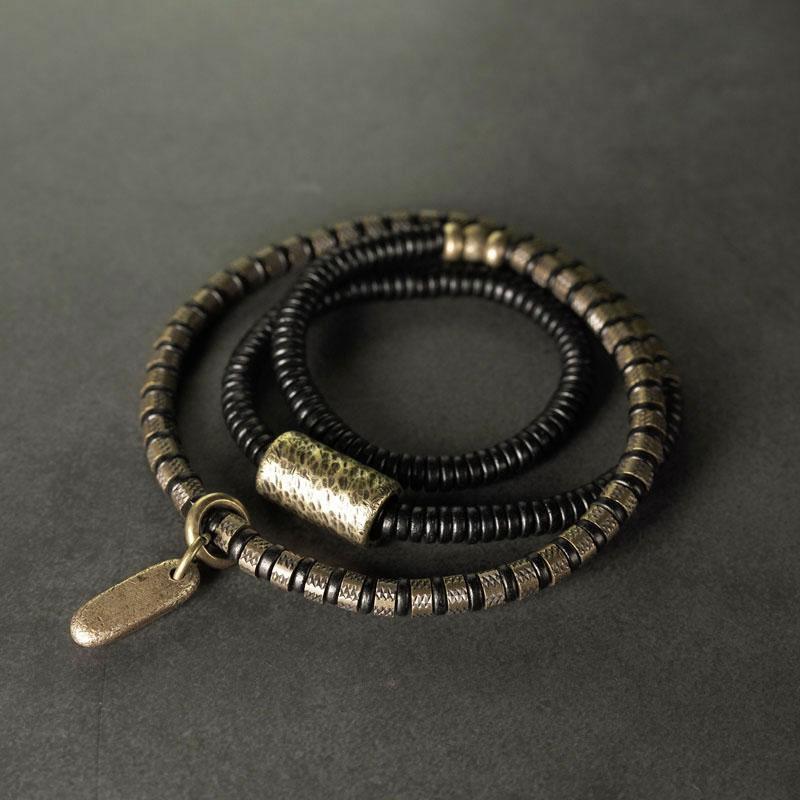 Close up of a vintage multilayered bracelet with black and gold tone beads