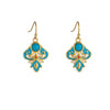 Pair of gold-tone drop earrings with blue enamel and faux turquoise stones resting on wood