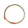 A close-up view of a braided multicolor string bracelet with a silver bead on a white background
