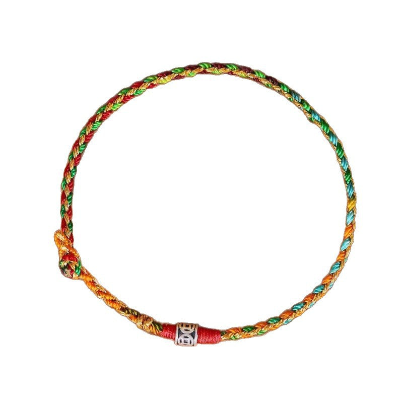 A close-up view of a braided multicolor string bracelet with a silver bead on a white background