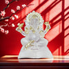 Front view of a translucent white resin Ganesha statue with gold details sitting on a wooden surface.