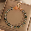 Close up of green phantom quartz bead bracelet with gold tone gourd charm and pearl