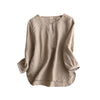 Beige linen cotton women's shirt hanging on a wooden hanger