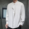 Man wearing a white long sleeve linen shirt with a stand collar