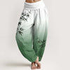 Woman wearing white and green gradient harem pants with bamboo print