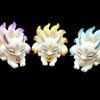 White carved nine-tailed fox figurine lying down on a black background