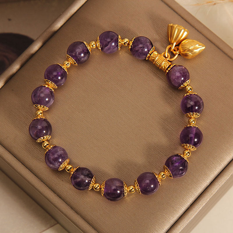 Purple amethyst beaded bracelet with gold lotus seed pod charm