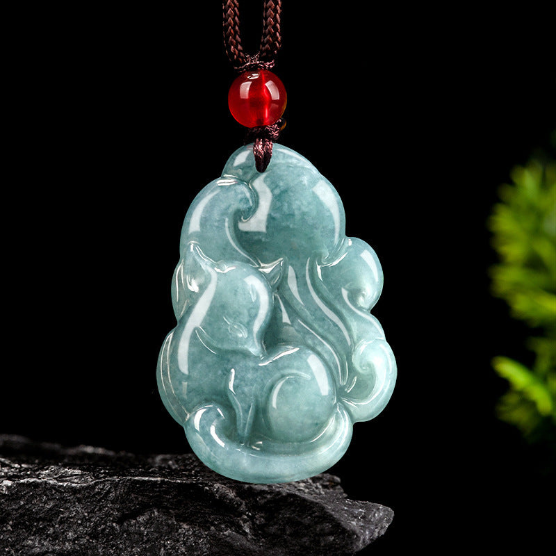 Carved light blue jade pendant shaped like a nine-tailed fox on a brown cord