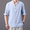 Man wearing a light blue cotton linen half sleeve button shirt with a stand collar