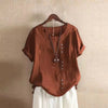 Brown short sleeve women's t-shirt with buttons hanging on a wooden hanger