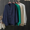 Beige linen cotton shirt with traditional knot buttons hanging on a wooden hanger