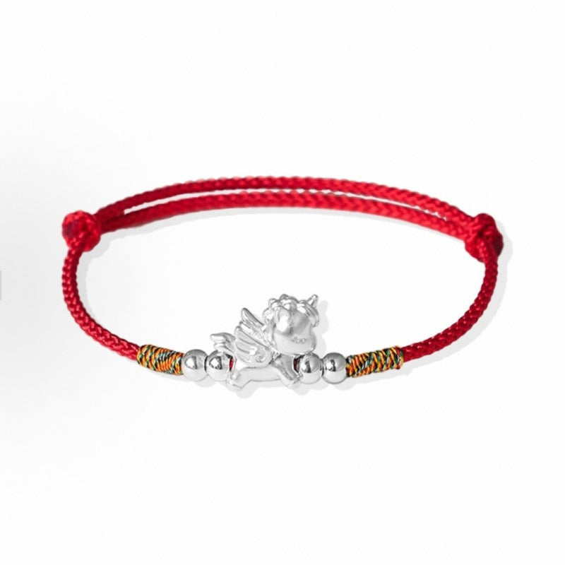 Flying horse charm on a red braided cord bracelet