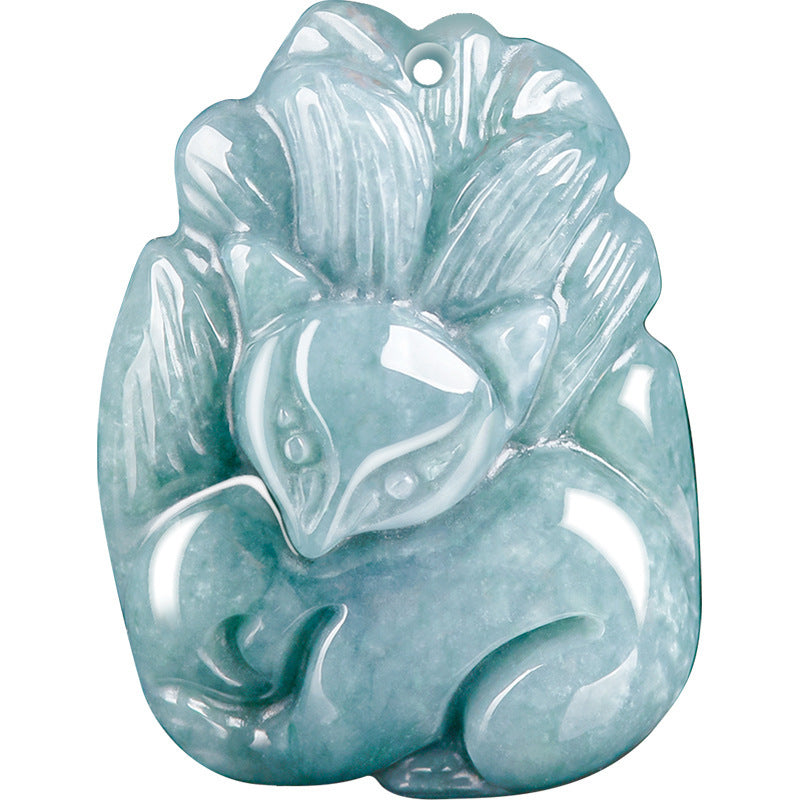 Close up of a carved blue green jade pendant shaped like a nine tailed fox on a brown cord
