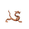 Antique brass dragon figurine serving as a pen holder on a white background