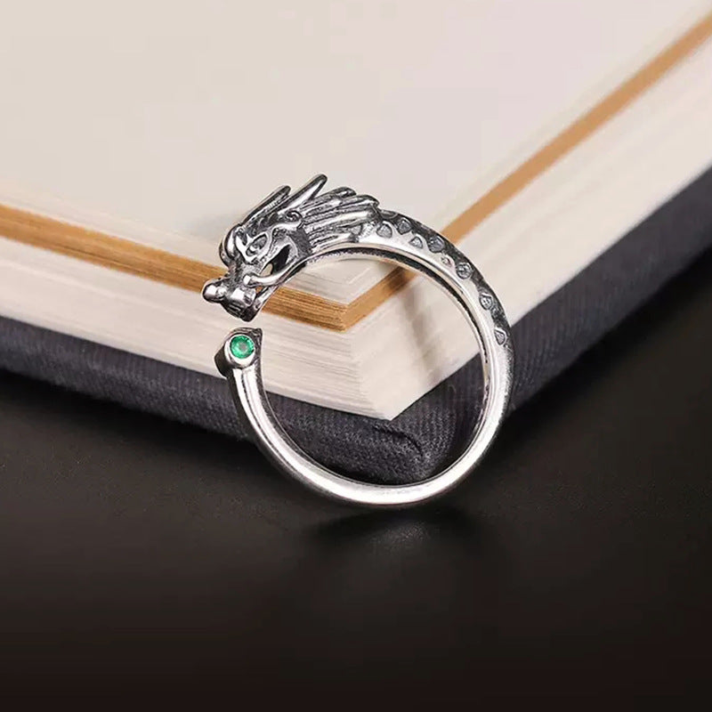Silver tone adjustable ring with a vintage dragon head design and a small green stone