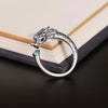Silver tone adjustable ring with a vintage dragon head design and a small green stone