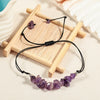 Close up of a purple amethyst chip bracelet on a wooden stand