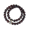 Double wrap dark brown bodhi seed bracelet with silver accent beads on white background