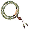 Close-up of a green sandalwood wood bracelet wrapped around a wrist with brown cord knots