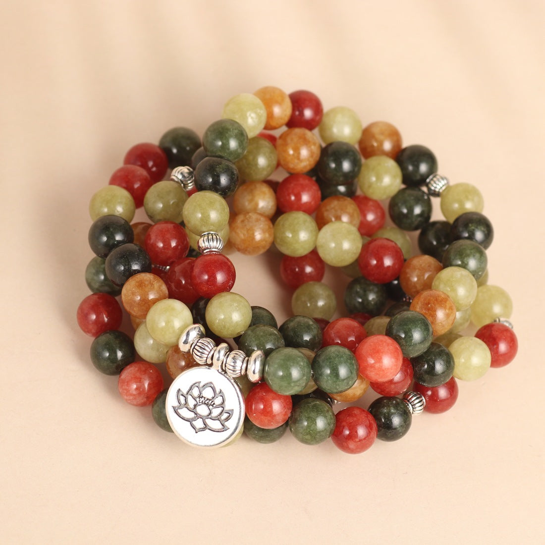 Coiled multicolored bead mala with a silver-tone lotus pendant charm
