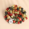 Coiled multicolored bead mala with a silver-tone lotus pendant charm