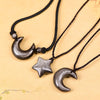 Close up of a silver sheen obsidian crescent moon pendant on a black cord