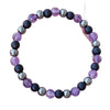 Beaded bracelet with alternating purple and black round stones on a white background