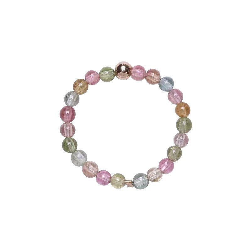 Close-up of a multi-colored crystal bead ring on a white background